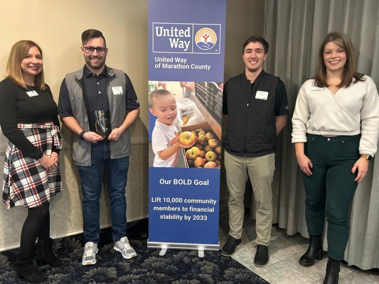 United way staff and Greenheck Group team members posing for an award